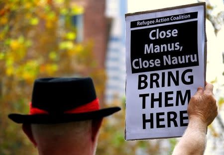 A protester from the Refugee Action Coalition holds a placard during a demonstration outside the offices of the Australian Government Department of Immigration and Border Protection in Sydney, Australia, April 29, 2016. REUTERS/David Gray