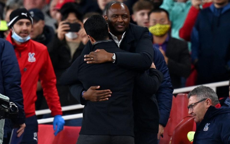 Crystal Palace's French manager Patrick Vieira (R) embraces Arsenal's Spanish manager Mikel Arteta  - AFP/Getty