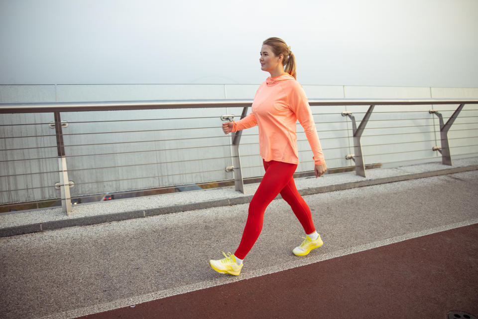 Charming sporty lady having race walking training outdoors stock photo