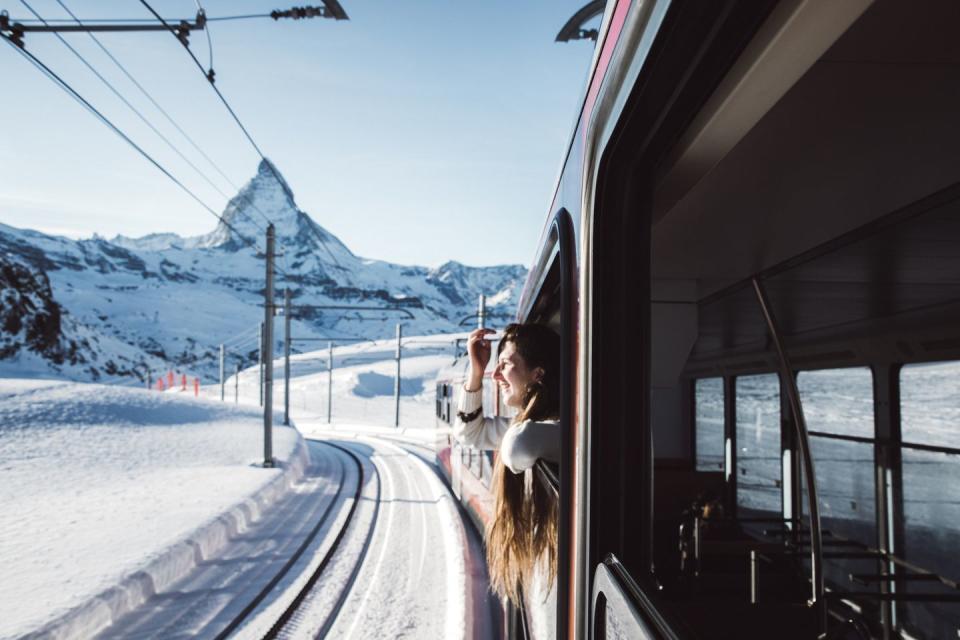 woman traveling by train looking at winter matterhorn from the window