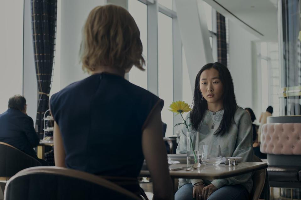 a person sitting at a table talking to a person