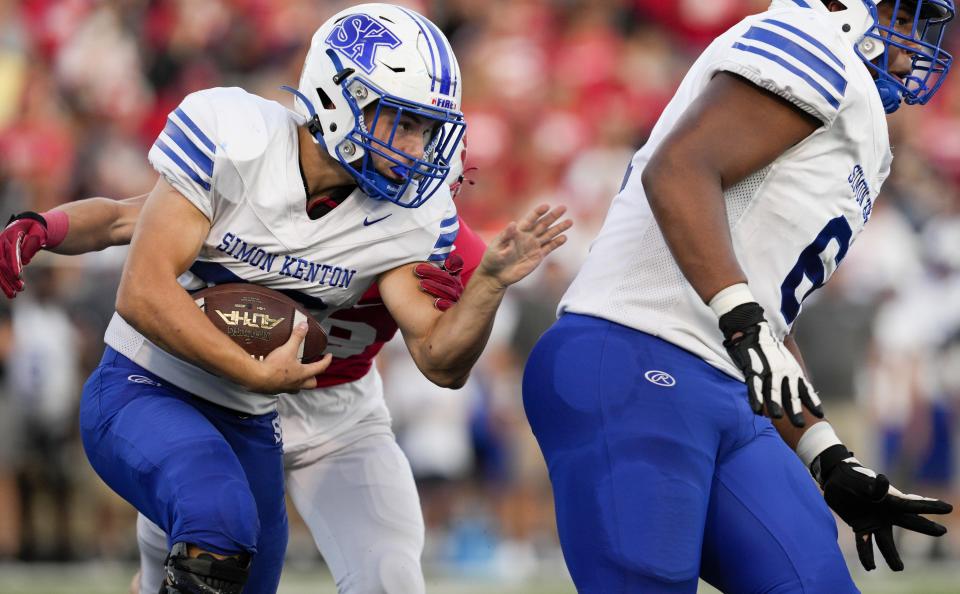 Simon Kenton's Julian Robles, left, runs with the ball during a KHSAA high school football game against the Beechwood Tigers at Beechwood High School Friday, Sept. 9, 2022, in Fort Mitchell, Ky.