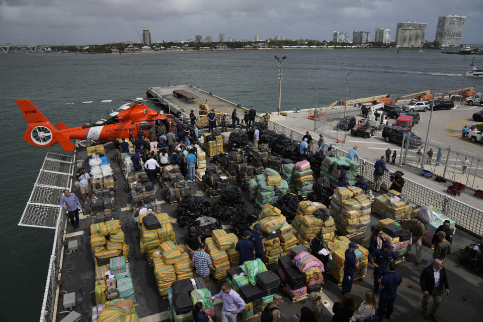 FILE - Journalists, politicians, and federal officials stand with members of the U.S. Coast Guard and other law enforcement agencies, at a display of more than one billion dollars worth of cocaine and marijuana aboard Coast Guard Cutter James at Port Everglades, Thursday, Feb. 17, 2022, in Fort Lauderdale, Fla., The drugs were seized from multiple interdictions in the Caribbean Sea and the eastern Pacific as part of Operation Panama Express. Joseph Ruddy, one of the nation’s most prolific federal narcotics prosecutors, is one of the architects of the task force launched in 2000 to target cocaine smuggling at sea, combining resources from the U.S. Coast Guard, FBI, Drug Enforcement Administration and Immigration and Customs Enforcement. (AP Photo/Rebecca Blackwell, File)