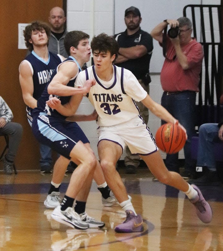 Micah Meiss (32) of El Paso-Gridley tries to get around Prairie Central's Gavin Tredennick Friday. Meiss led EPG with 23 points in a 62-42 victory.