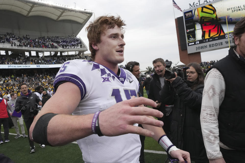 TCU quarterback Max Duggan (15) greets teammates and coaches after an win over Baylor in Waco, Texas, Saturday, Nov. 19, 2022. TCU won 29-28. (AP Photo/LM Otero)