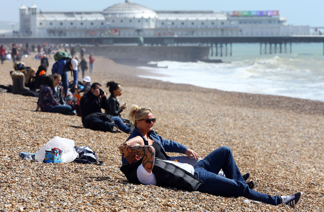 People enjoy the warm weather on the beach in Brighton (Picture: PA)