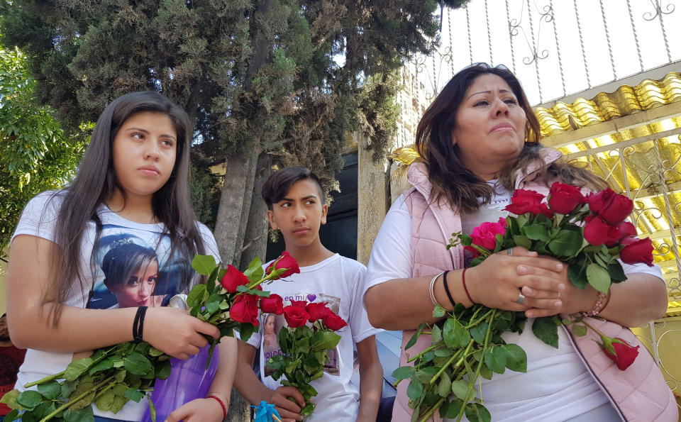 María Carreno, right, weeps during a remembrance ceremony in honor of her sister Briseida Carreno, who was killed a year ago, in Ecatepec, a suburb of Mexico City, Saturday, Nov. 23, 2019. It fell on Maria to identify the body, which she was able to do because of a tattoo on an upper arm. Briseida’s body had been charred and dumped unceremoniously on the street. (AP Photo/Alicia Guthrie)