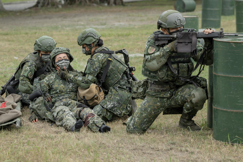 In this photo released by the Taiwan Presidential Office, Taiwanese soldiers go through a drill as Taiwan's President Tsai Ing-wen visits a camp in Hualien, in eastern Taiwan on Tuesday, Sept. 6, 2022. Taiwanese President Tsai Ing-wen said Tuesday that China is conducting "cognitive warfare" by spreading misinformation in addition to its regular incursions into nearby waters and airspace intended at intimidating the self-governing island. (Taiwan Presidential Office via AP)