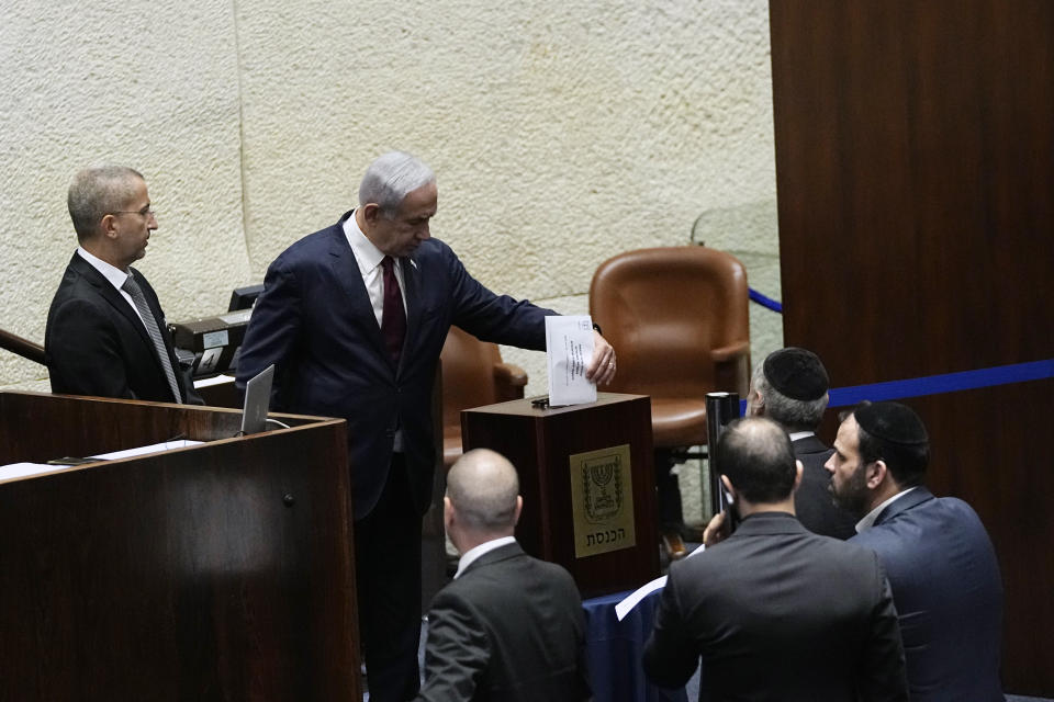 Israeli Prime Minister Benjamin Netanyahu casts his vote on picking two lawmakers to serve on a judge selection panel, in the Knesset, Israel's parliament, Jerusalem, Wednesday, June 14, 2023. (AP Photo/Ohad Zwigenberg)
