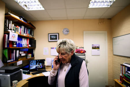 Jeanette Warke M.B.E., 73, speaks on the phone inside the Cathedral Youth Club that she runs in the walled-off loyalist Protestant enclave called The Fountain situated within the city of Londonderry, Northern Ireland, September 12, 2017. REUTERS/Clodagh Kilcoyne