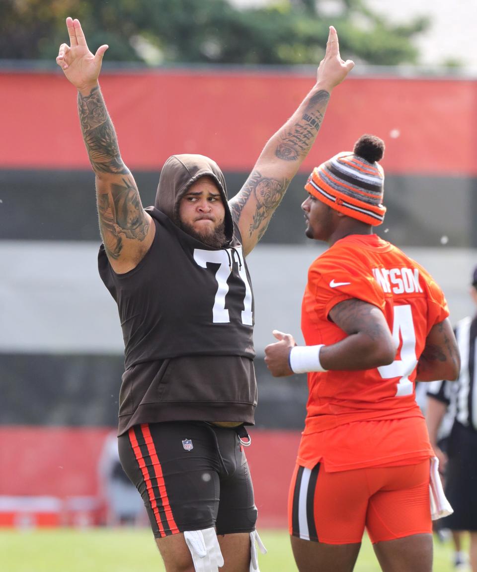 Cleveland Browns left tackle Jedrick Wills likes what he sees from a pass from quarterback Deshaun Watson during OTA workouts on Wednesday, June 1, 2022 in Berea.