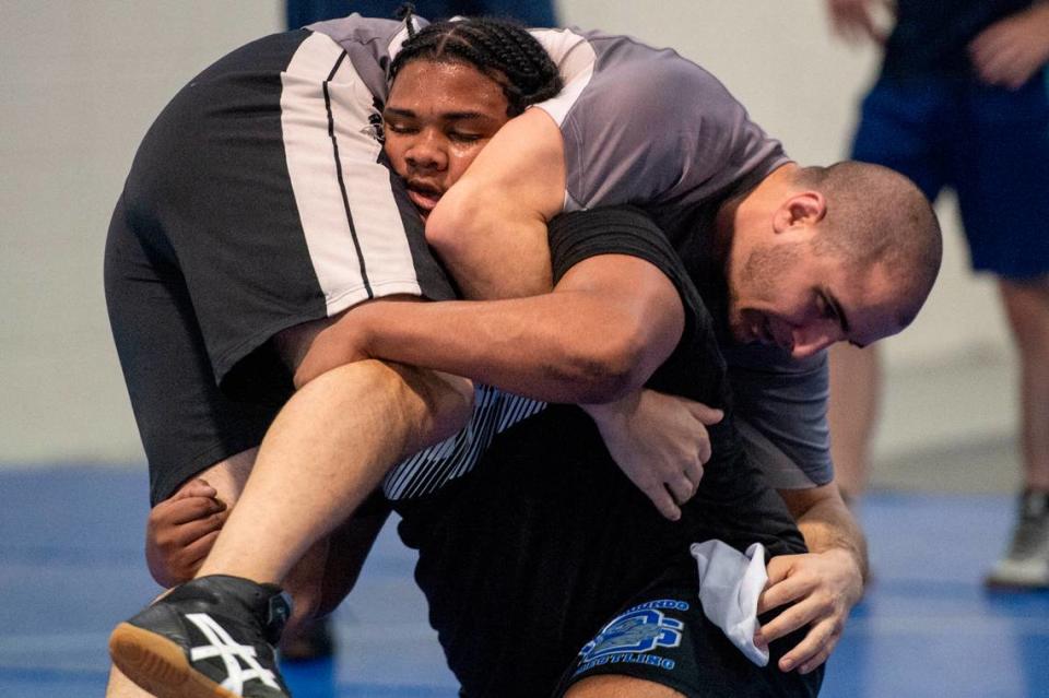 Xavier Smith and assistant coach Nick Bruce practice together during Ocean Springs’ high school wrestling practice at E.H. Keys Alternative Education Center on Thursday, Feb. 8, 2024.