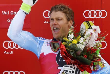 Steven Nyman of the U.S. celebrates on the podium after winning the men's World Cup Downhill skiing race in Val Gardena December 19, 2014. REUTERS/Stefano Rellandini