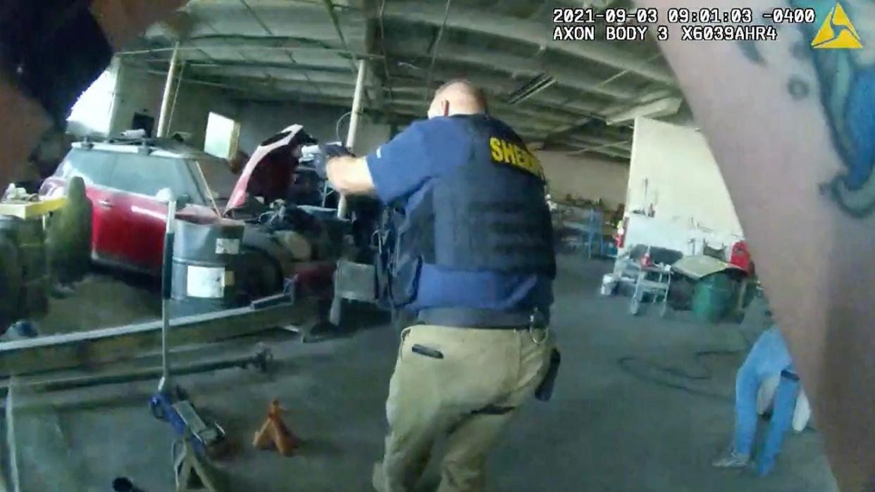 Officer body camera footage shows Knox County Sheriff's Office fire investigator Jerry Glenn during a 2021 raid on what the sheriff's office suspects was a catalytic converter theft operation.