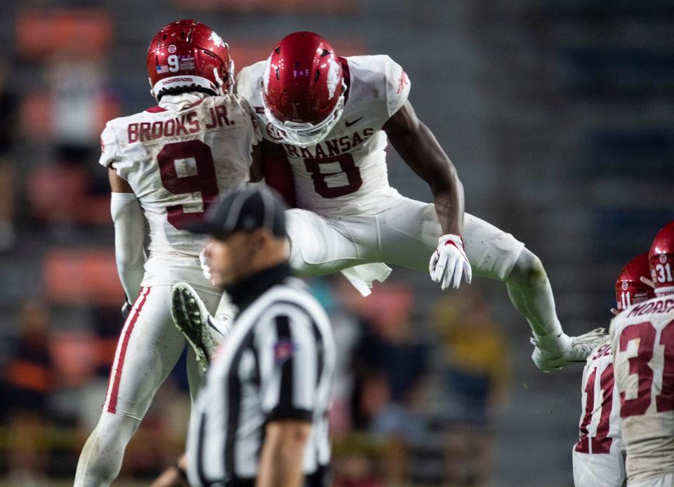 Arkansas defensive back Greg Brooks Jr. (9) and Arkansas wide receiver Mike Woods (8) celebrate after making a stop late in the game at Jordan Hare Stadium in Auburn, Ala., on Saturday, Oct. 10, 2020. Auburn defeated Arkansas 30-28.