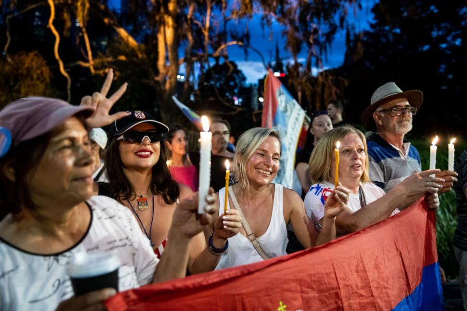 Novak Djokovic supporters rally outside Melbourne’s Park Hotel where he was thought to have been taken (Getty Images)