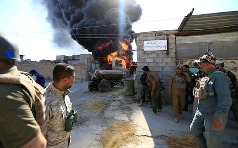  Smoke rises during clashes between joint troops of Iraqi army and Shi'ite Popular Mobilization Forces (PMF) against the Islamic State militants in Tal Afar - Credit: REUTERS/Thaier Al-Sudani