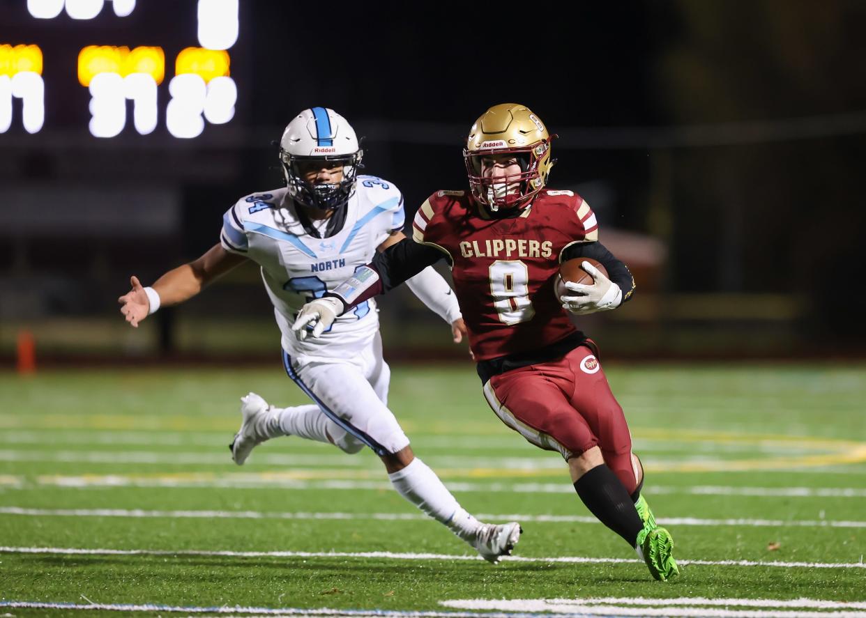 Portsmouth's Angus Moss runs past Nashua North's Steven Rosario and scores a touchdown in last Friday's Division I quarterfinal game at Tom Daubney Field.