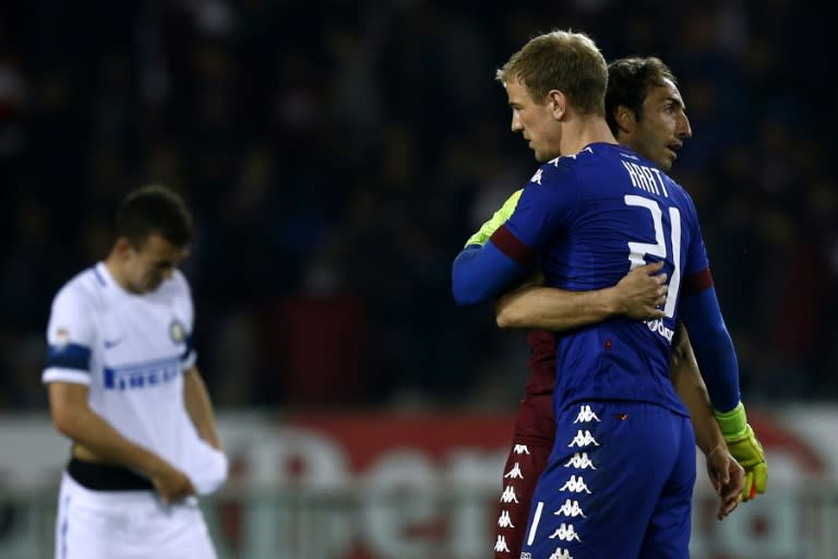 Torino's Joe Hart celebrates with Torino's Cristian Molinaro (R) after an Italian Serie A football match against Inter Milan on March 18, 2017