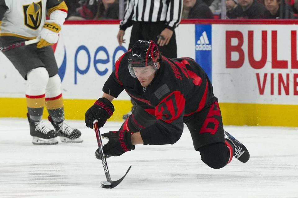 Carolina Hurricanes right wing Andrei Svechnikov (37) fall while skates with the puck against the Vegas Golden Knights during the first period at PNC Arena.