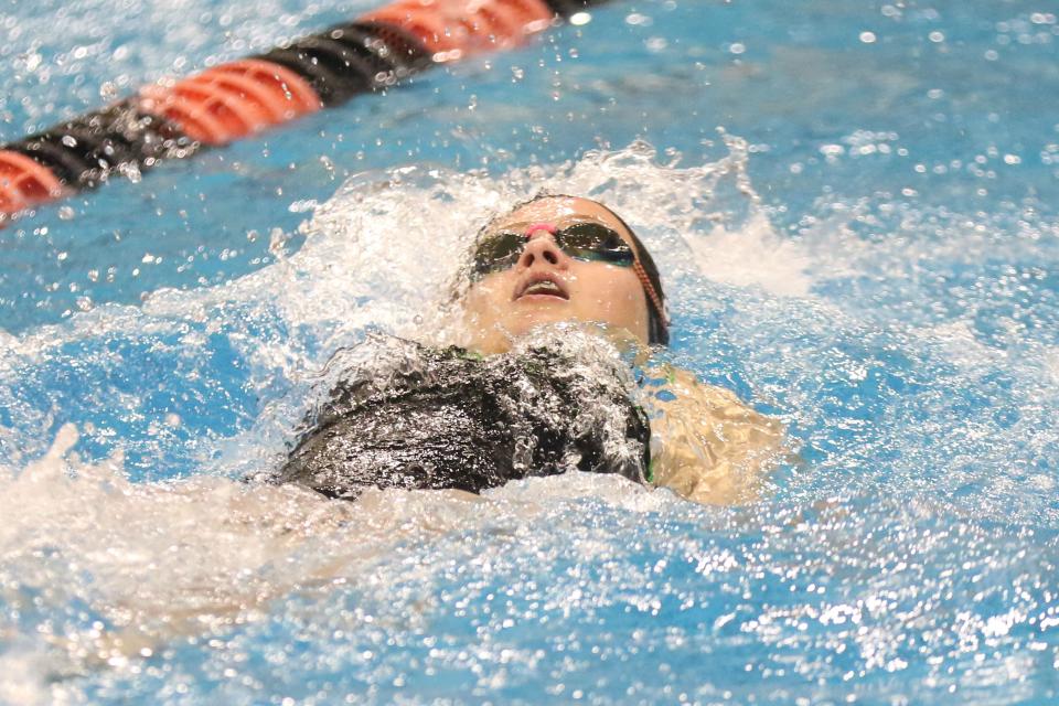 Oak Harbor's Alyse Sorg swims the 100 yard backstroke.