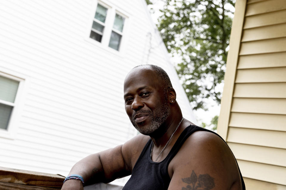 Harold Lewis, a recovering drug user, sits on the porch of his mother's house, Monday, July 18, 2022 in Stratford, Conn. For Lewis, in recovery from opioids, a weekly prize drawing became a way for him to bring home gifts for his mother. “The prizes make me feel good," he said. “But the prizes make my mother feel great. I’m talking Tony the Tiger GREAT!” (AP Photo/Julia Nikhinson)