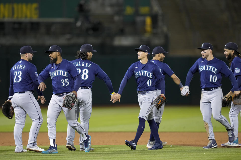 Seattle Mariners players celebrate after the team's 2-1 victory over the Oakland Athletics in a baseball game in Oakland, Calif., Tuesday, May 2, 2023. (AP Photo/Godofredo A. Vásquez)