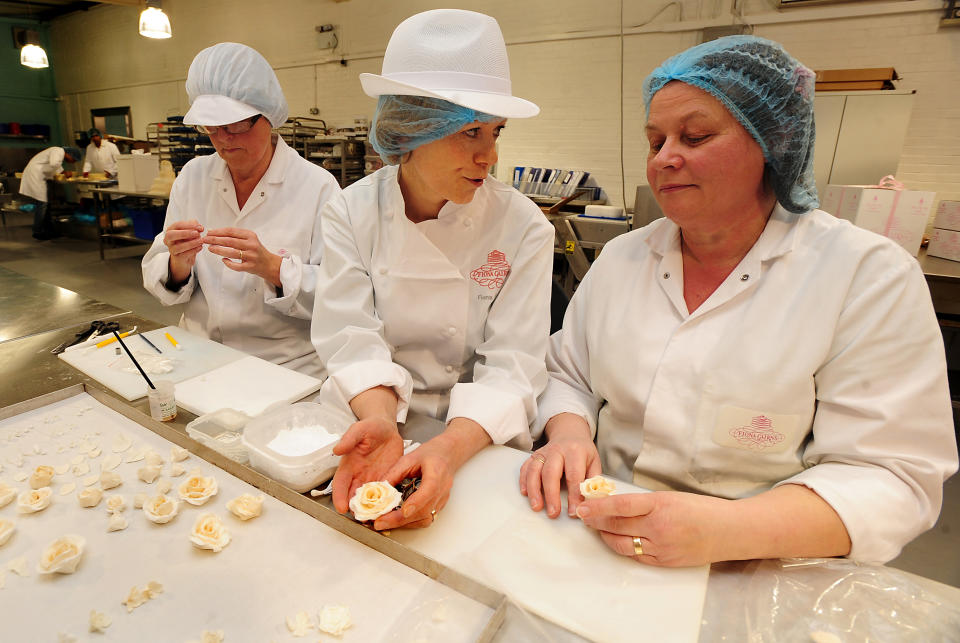 FLECKNEY, UNITED KINGDOM - MARCH 24: Cake designer Fiona Cairns (C),  Mary Doody (R) and Diane Pallet make decorations for the royal wedding cake, on March 24, 2011 in Fleckney, Leicestershire, England. The wedding will take place on April 29, 2011. (Photo by Rui Vieira - WPA Pool/Getty Images)