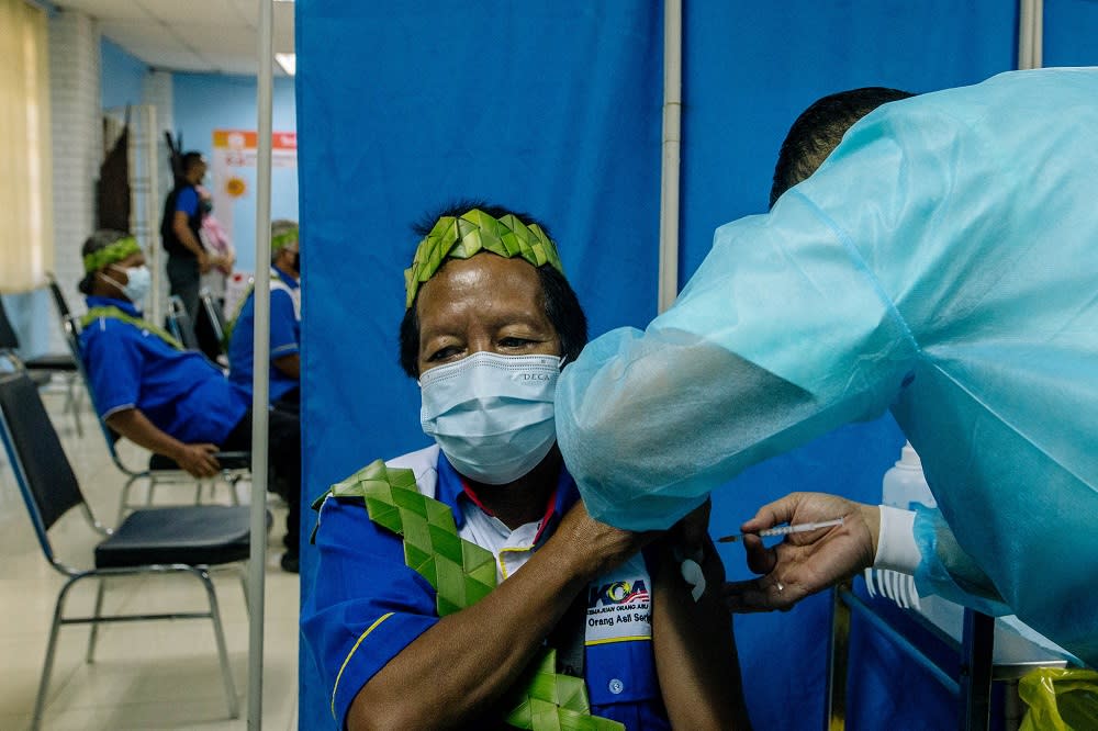 A man from the Orang Asli community receives a dose of the Covid-19 vaccine in Gombak June 19, 2021. ― Picture by Firdaus Latif