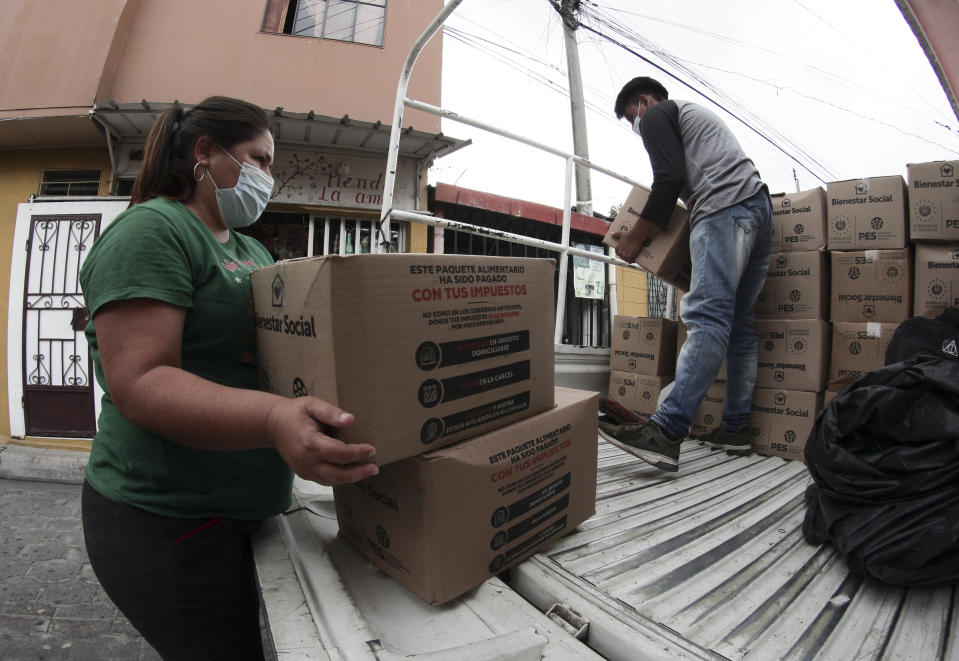 Government employees load boxes of food staples to be delivered to the families living in the gang-controlled Las Palmas neighborhood, in San Salvador, El Salvador, Thursday, June 3, 2021. Las Palmas residents say they are grateful for the food kits they've received from Bukele's government during the new coronavirus pandemic. (AP Photo/Salvador Melendez)