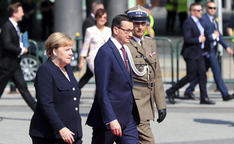 German Chancellor Angela Merkel, left, arrives with Polish Prime Minister Mateusz Morawiecki for a memorial ceremony marking the 80th anniversary of the start of World War II in Warsaw, Poland, Sunday, Sept. 1, 2019.(AP Photo/Czarek Sokolowski)