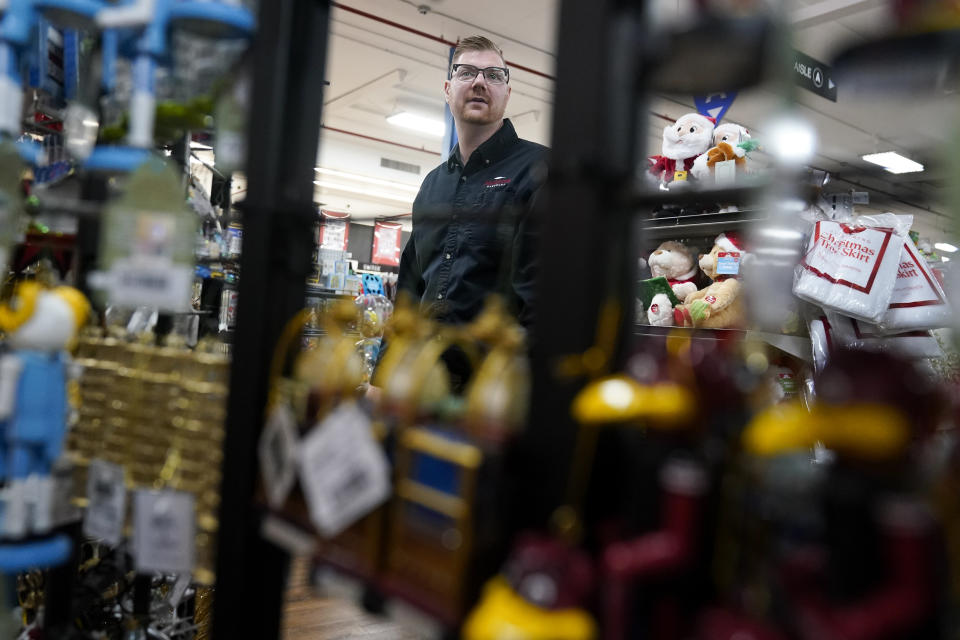 Andy Wilkerson, co-owner of Blackhawk Hardware, gives a tour of the holiday decorations section in his retail store, Wednesday, Nov. 1, 2023, in Charlotte, N.C. Holiday entertaining is back this year, and the store is seeing an influx of shoppers buying place settings, ornaments and indoor decorations. (AP Photo/Erik Verduzco)