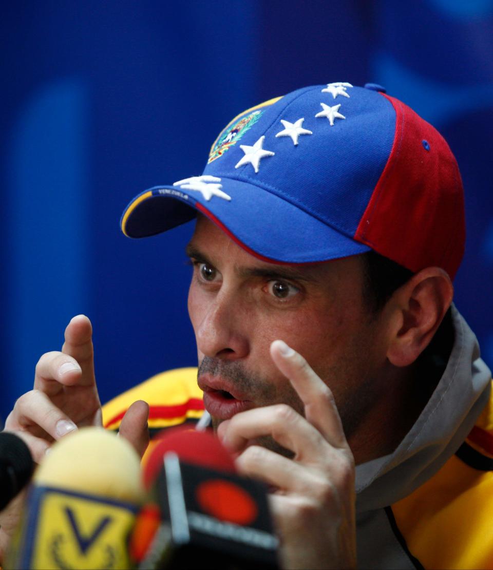 Opposition leader Henrique Capriles speaks during a news conference at his office in Caracas, Venezuela, Thursday, Feb. 20, 2014. The opposition is planning marches across the country on Saturday to protest the jailing of opposition leader Leopoldo Lopez, which has made him a cause celebre among opponents of President Maduro. Capriles, the opposition's two-time presidential candidate is now being eclipsed by Lopez as leader of the opposition. (AP Photo/Alejandro Cegarra)