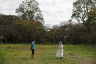 A man in quarantine is interviewed by a member of the National Mechanism to Prevent Torture (MNPT), as the institution visits a Catholic church property turned into a government-run shelter where citizens returning home are required by law to quarantine for two weeks and pass two consecutive COVID-19 tests, as a preventive measure amid the COVID-19 pandemic near Asuncion, Paraguay, Thursday, June 18, 2020. Along with Paraguay's relative isolation, experts credit the country's success at controlling the spread of COVID-19 with creating a network of quarantine centers in military academies, motels, and religious institutions before being able to move about the country freely. (AP Photo/Jorge Saenz)