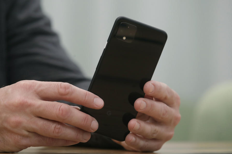 In this Tuesday, Sept. 24, 2019, photo Rick Osterloh, SVP of Google Hardware holds a new Pixel 4 phone while interviewed in Mountain View, Calif. (AP Photo/Jeff Chiu)