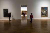 Visitors look at paintings from the collection of the National Art Gallery of Kyiv during the "From Dusk To Dawn" exhibition at the Rath Museum in Geneva