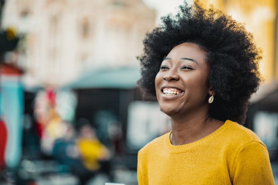 sun-damage-on-dark-skin-tones, dark-skin-woman-smiling