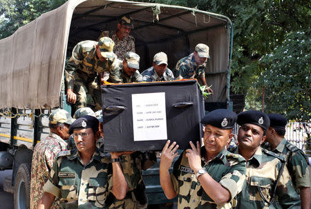 Indian Border Security Force (BSF) officers carry the coffin of their fallen colleague, who died after shelling across the border between India and Pakistan, during a wreath laying ceremony at their headquarters on the outskirts of Jammu October 24, 2016. REUTERS/Mukesh Gupta