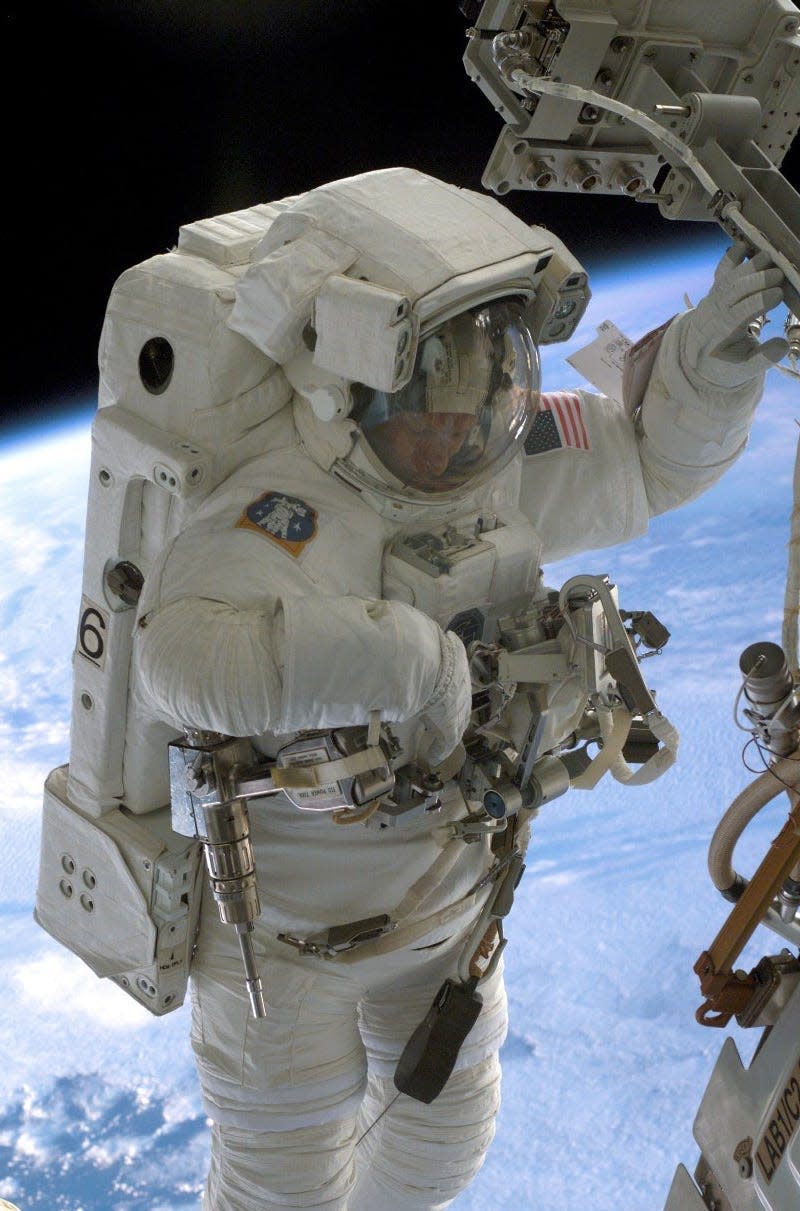 Astronaut Piers Sellers outside the International Space Station in a spacesuit