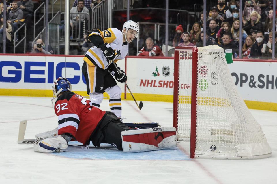 Dec 19, 2021; Newark, New Jersey, USA; Pittsburgh Penguins center Teddy Blueger (53) scores a goal past New Jersey Devils goaltender Jon Gillies (32) during the first period at Prudential Center. Mandatory Credit: Vincent Carchietta-USA TODAY Sports