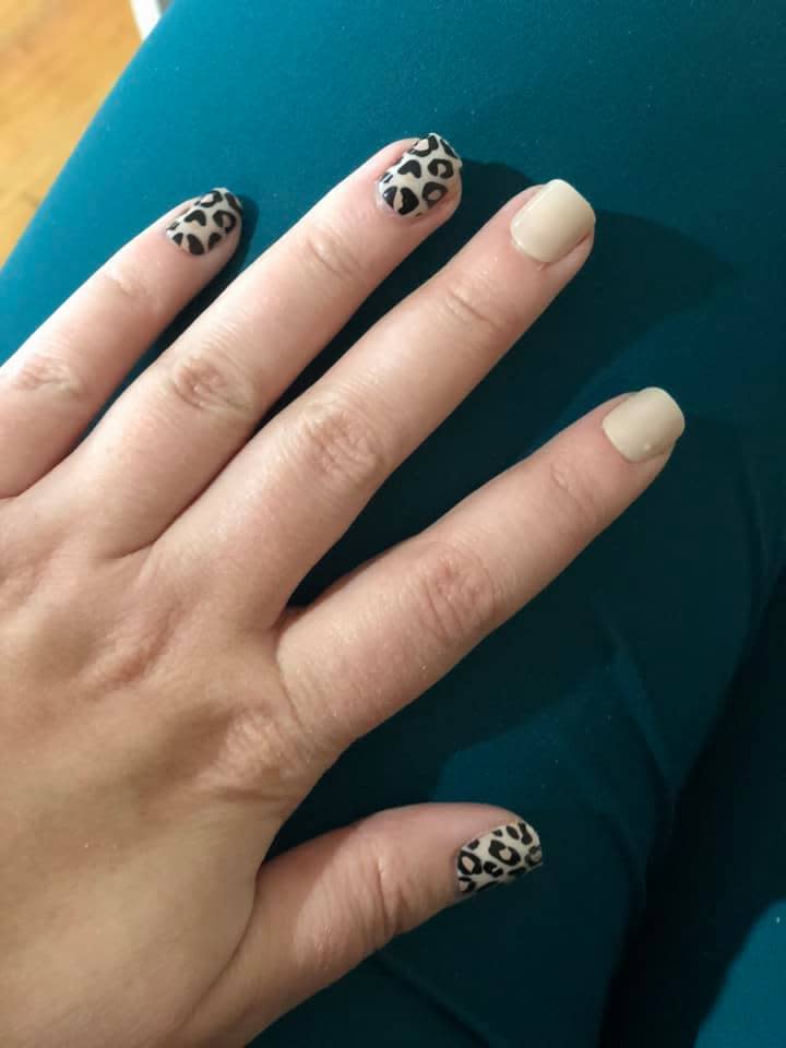 Image of woman's hand with OXX Kmart fake nails