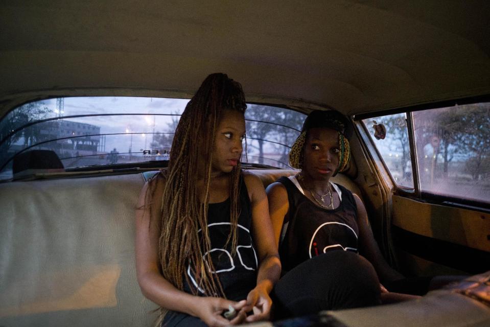 In this Jan. 30, 2017 photo, boxers Idamelys Moreno, left, and Legnis Cala, ride home in a taxi after training, in Havana, Cuba. Female athletes in Cuba have made strides in many other sports, including wrestling, judo and most recently, weightlifting, but not in boxing. (AP Photo/Ramon Espinosa)