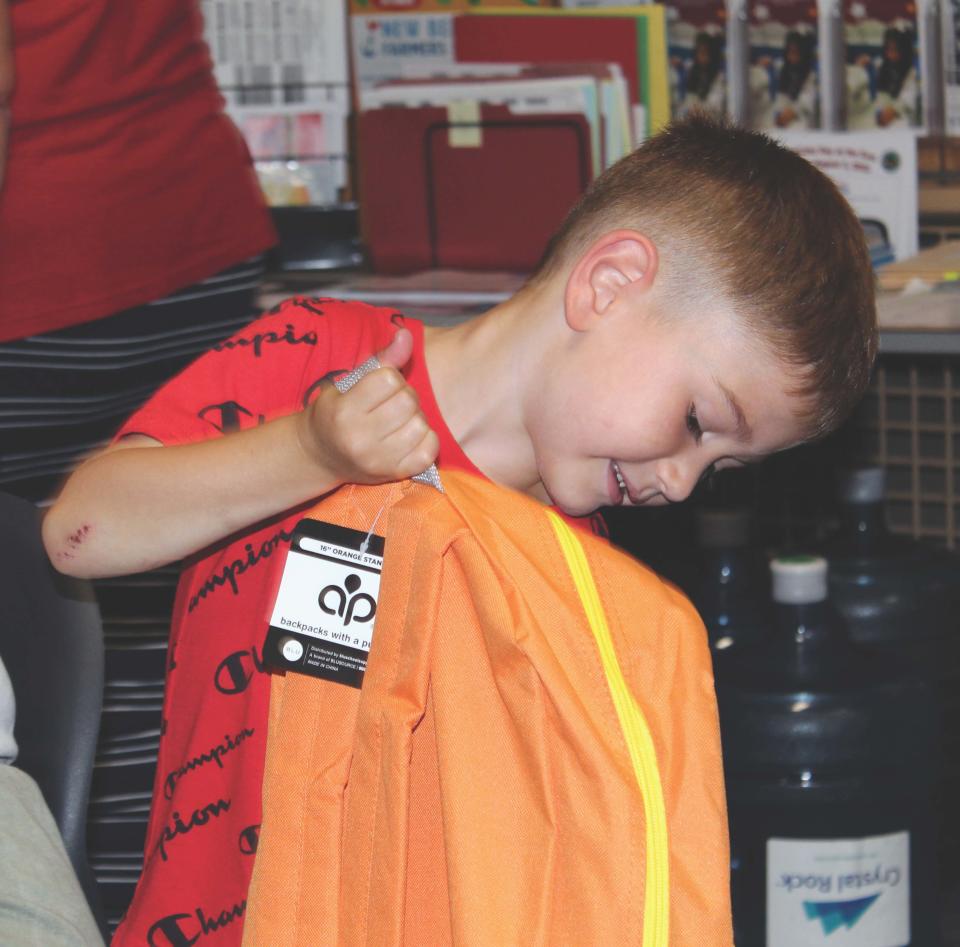 A student checks out his new backpack at the Paul Rodrigues Administration building in New Bedford.