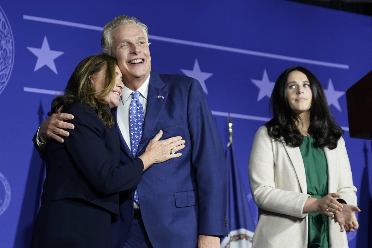 Democratic gubernatorial candidate Terry McAuliffe, right, hugs his wife, Dorothy, as he makes an appearance at an election night party in McLean, Va., Tuesday, Nov. 2, 2021. Voters are deciding between Democrat Terry McAuliffe and Republican Glenn Youngkin. (AP Photo/Steve Helber)