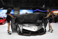 Booth professionals unveiling the Lamborghini Veneno, a $4 million supercar that will only be made for three owners.