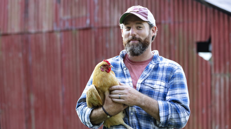 Farmer holding a chicken
