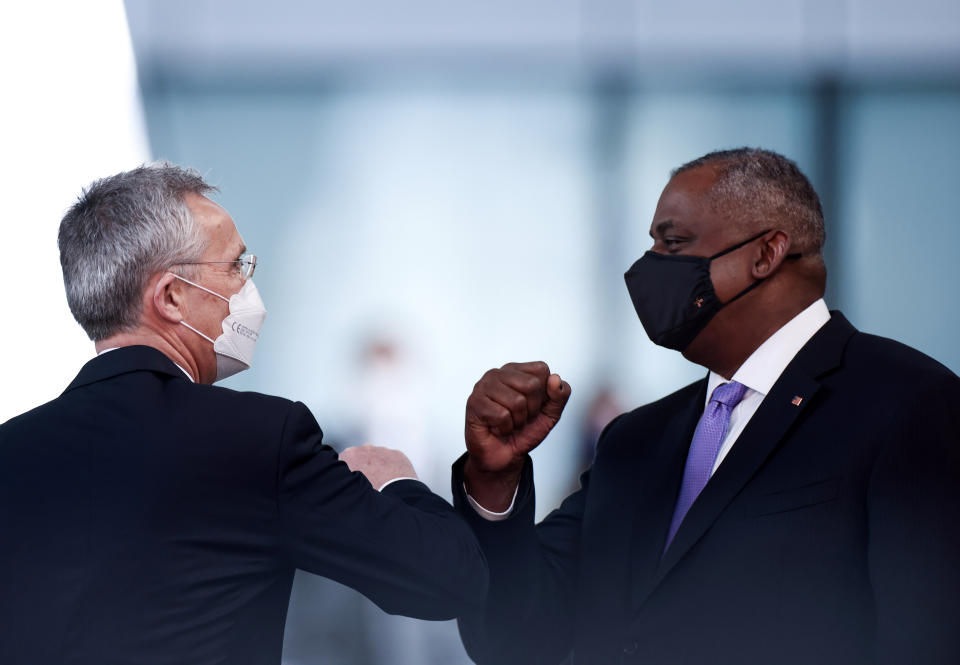 United State Secretary of Defense Lloyd Austin, right, is greeted with an elbow bump by NATO Secretary General Jens Stoltenberg prior to a meeting at NATO headquarters in Brussels, Wednesday, April 14, 2021. (Kenzo Tribouillard, Pool via AP)