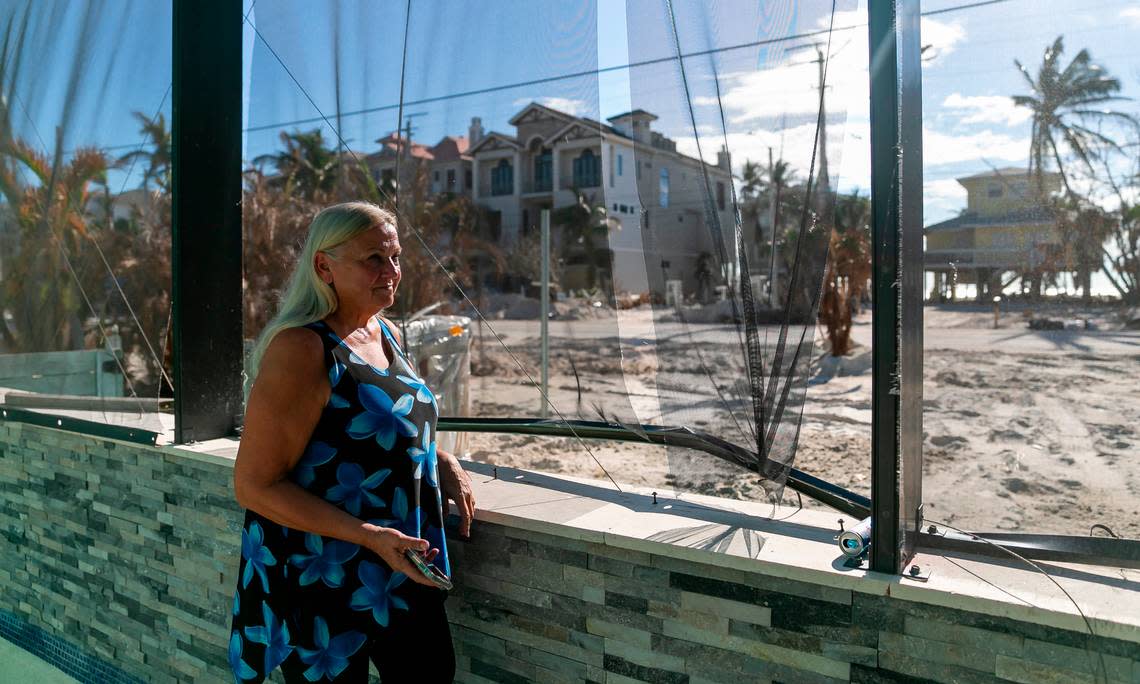 Heidi Christianson, 66, a retired landlord, stands by the pool screen that was damaged by Hurricane Ian inside her home in Bonita Beach, Florida.