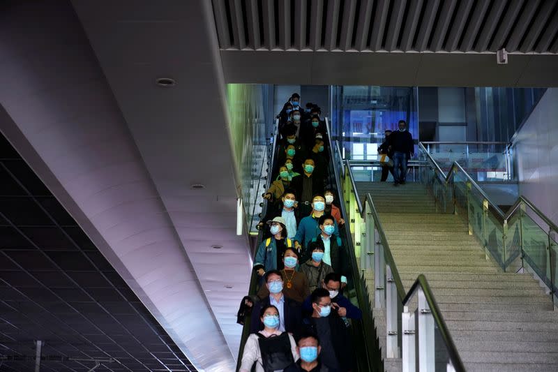 People wearing face masks amid the global outbreak of the coronavirus disease (COVID-19) are seen at Shanghai Hongqiao Railway Station in Shanghai