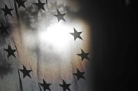 The stars of the EU flag are seen against the sun at the Europa House in London, Monday, Oct. 19, 2020. According to media reports, European Commission vice president Maros Sefcovic has met Chancellor of the Duchy of Lancaster Michael Gove for talks on the EU-UK trade deal. (AP Photo/Frank Augstein)